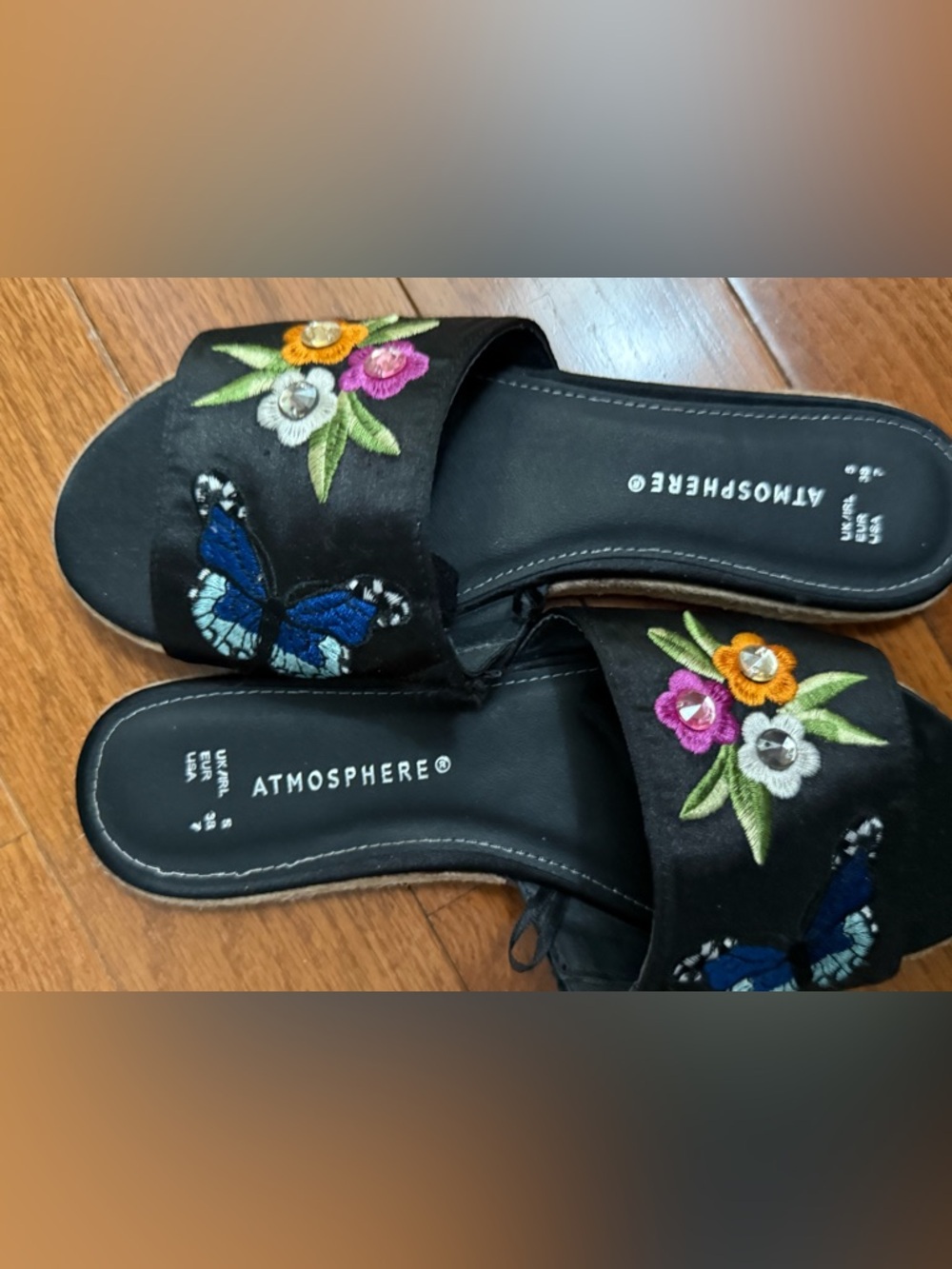 Atmosphere Black Slide Sandals with Floral and Blue Butterfly Embroidery.